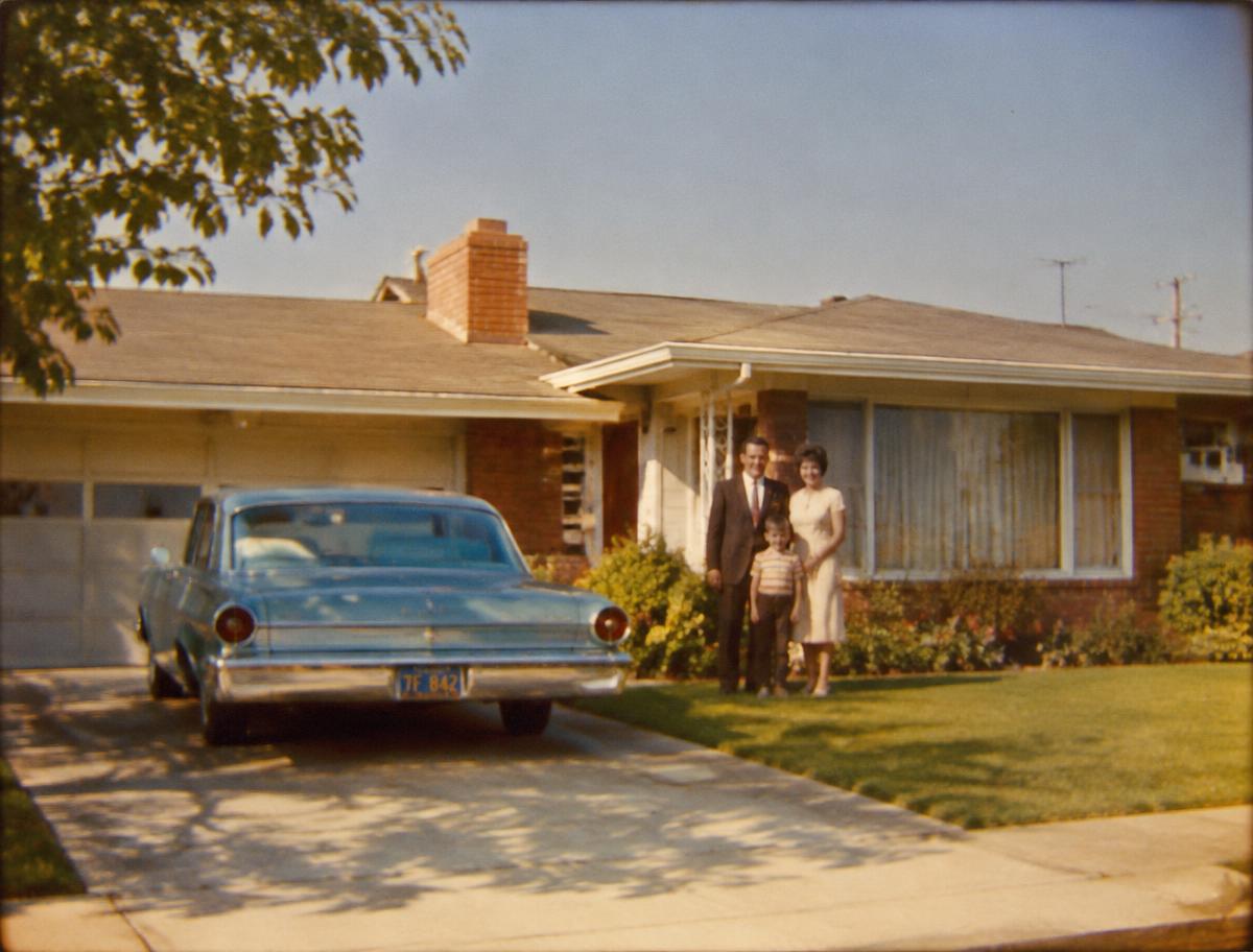 A 1960s family outside their home